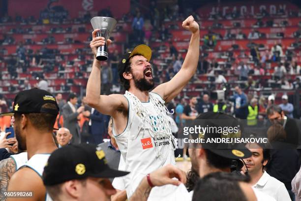 Real Madrid's Spanish guard Sergio Llull celebrates after cutting the net down with team mates their 85-80 win over Fenerbahce in the Euroleague...