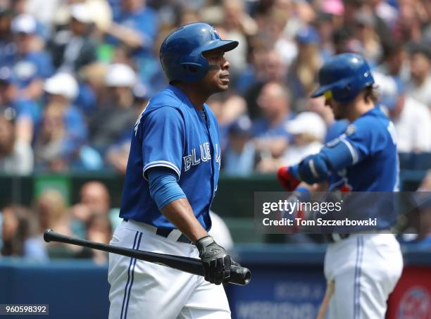 Curtis Granderson of the Toronto Blue Jays reacts after striking out in the third inning as Josh Donaldson looks on from the on-deck circle during...