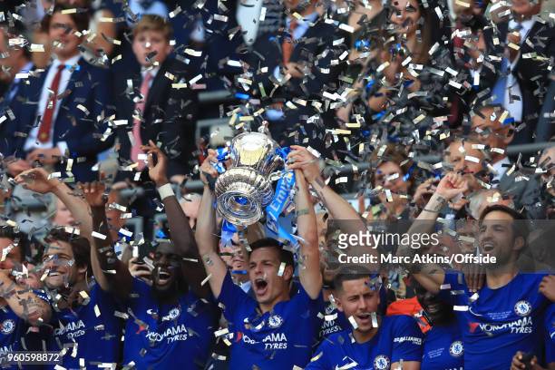 Cesar Azpilicueta of Chelsea lifts the trophy surrounded by team mates during The Emirates FA Cup Final between Chelsea and Manchester United at...