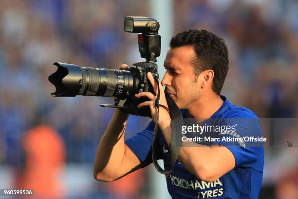 Pedro of Chelsea picks up a photographers camera during The Emirates FA Cup Final between Chelsea and Manchester United at Wembley Stadium on May 19,...