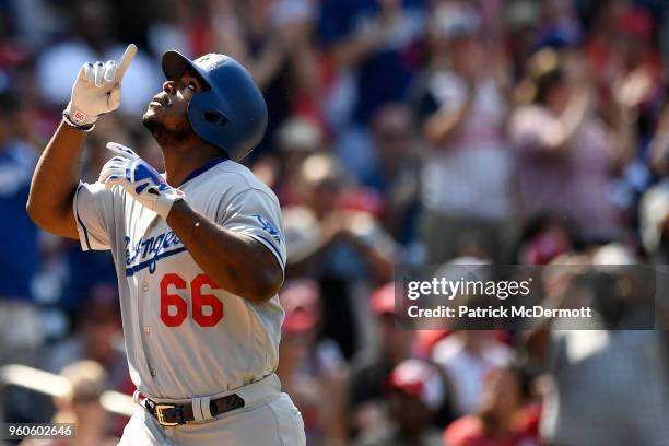 Yasiel Puig of the Los Angeles Dodgers reacts after hitting a two-run home run in the eighth inning against the Washington Nationals at Nationals...