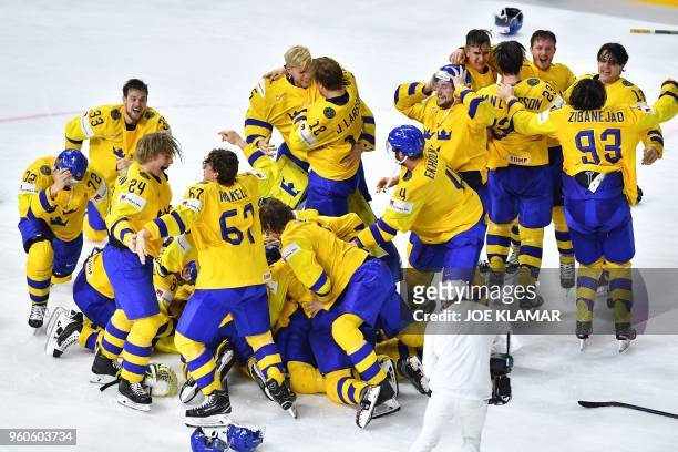 Sweden's players celebrate after the final match Sweden vs Switzerland of the 2018 IIHF Ice Hockey World Championship at the Royal Arena in...