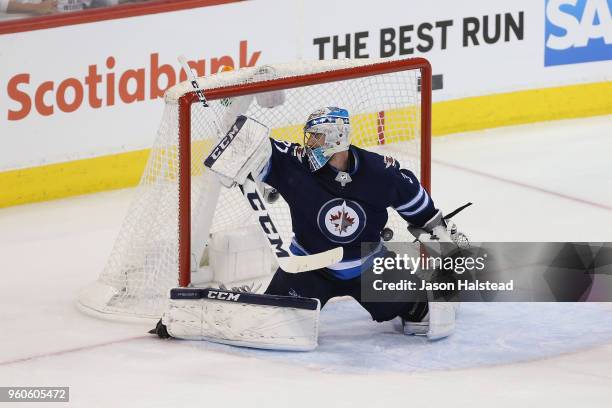 Connor Hellebuyck of the Winnipeg Jets allows a goal to Ryan Reaves of the Vegas Golden Knights during the second period in Game Five of the Western...