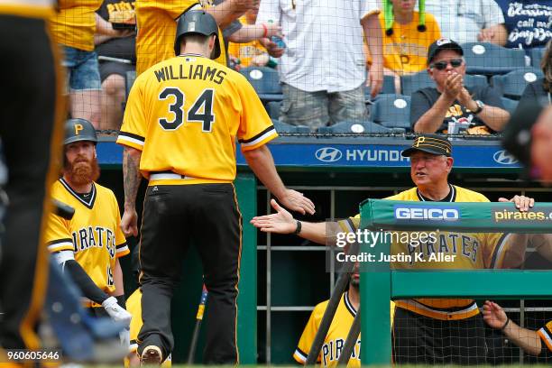 Trevor Williams of the Pittsburgh Pirates celebrates with manager Clint Hurdle after scoring on a sacrifice fly in the third inning against the San...