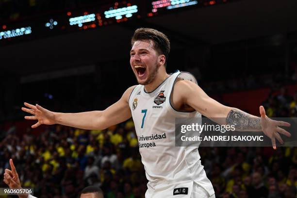 Real Madrid's Slovenian Luka Doncic jumps over the barrier as the team celebrates their 85-80 win over Fenerbahce in the Euroleague Final Four finals...