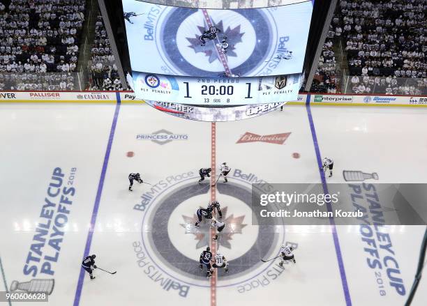 Bryan Little of the Winnipeg Jets and Jonathan Marchessault of the Vegas Golden Knights take the opening face-off of the second period in Game Five...