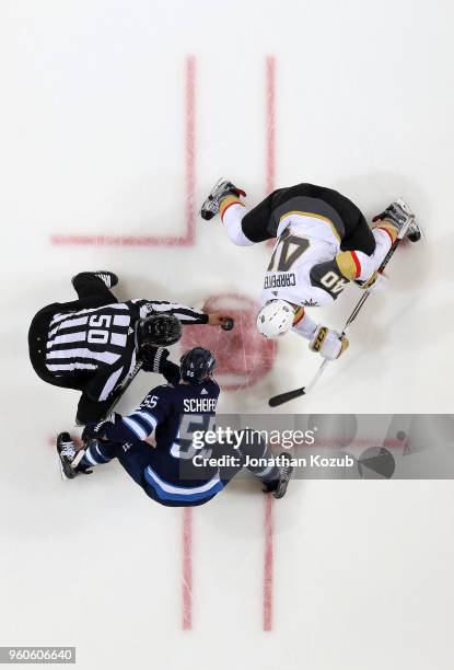 Ryan Carpenter of the Vegas Golden Knights gets set to take a second period face-off against Mark Scheifele of the Winnipeg Jets in Game Five of the...