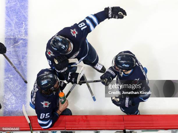 Mathieu Perreault, Bryan Little and Jack Roslovic of the Winnipeg Jets discuss strategy during a second period stoppage in play against the Vegas...