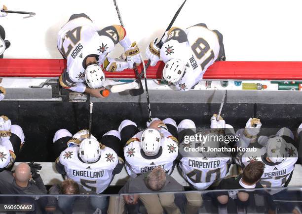 Luca Sbisa and James Neal of the Vegas Golden Knights chat with teammates at the bench during a second period stoppage in play against the Winnipeg...