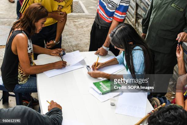 Voters seen registering themselves to vote outside one of the polling stations. The presidential elections called by the National Constituent...