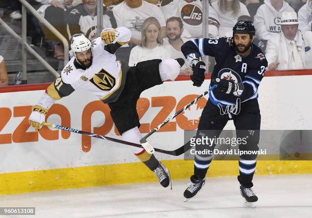 Dustin Byfuglien of the Winnipeg Jets checks Pierre-Edouard Bellemare of the Vegas Golden Knights during the third period in Game Five of the Western...