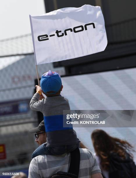 Little supporter of Audi-Sport waving the flag of hes favourite team in BMW Berlin E-Prix in Flughafen Tempelhof Airport.