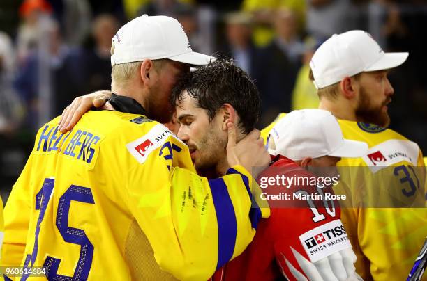 Magnus Hellberg of Sweden comforts Raphael Diaz of Switzerland after the 2018 IIHF Ice Hockey World Championship Gold Medal Game game between Sweden...