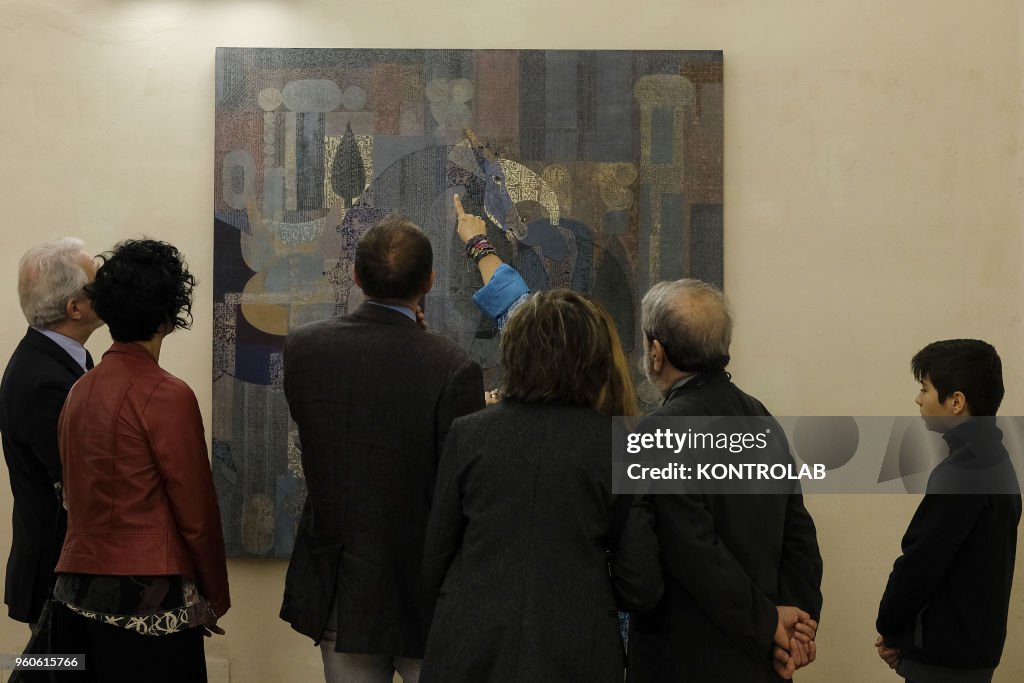 Visitors look a painting of Iranian artist Mohamad Hadi...