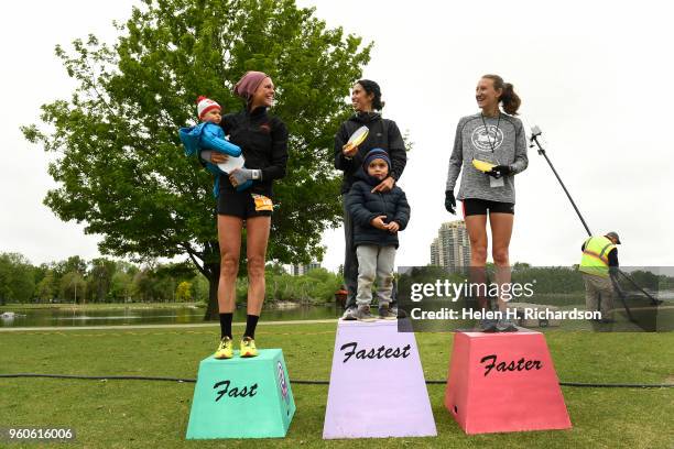 Malika Camacho winner of the women's Colfax half marathon, middle, stands with her son Ziad as she is flanked by second place finisher Amanda Scott...