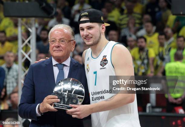 Luka Doncic, #7 of Real Madrid receive the MVP of the Final Trophy from Dusko Ivkovic, during the 2018 Turkish Airlines EuroLeague F4 Champion Trophy...