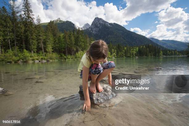 girl plays in a mountain lake - bavaria girl stock pictures, royalty-free photos & images