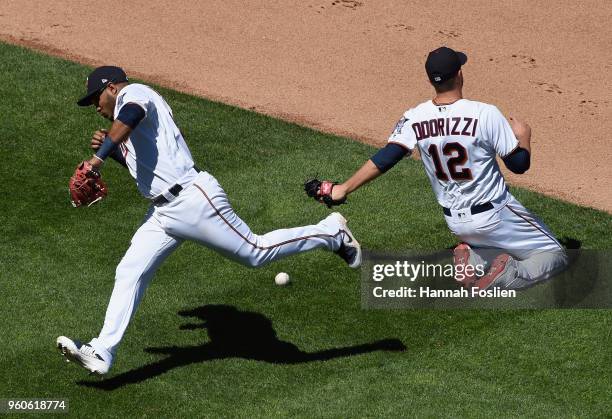 Gregorio Petit and Jake Odorizzi of the Minnesota Twins attempt to make a play on the ball hit by Tyler Saladino of the Milwaukee Brewers during the...