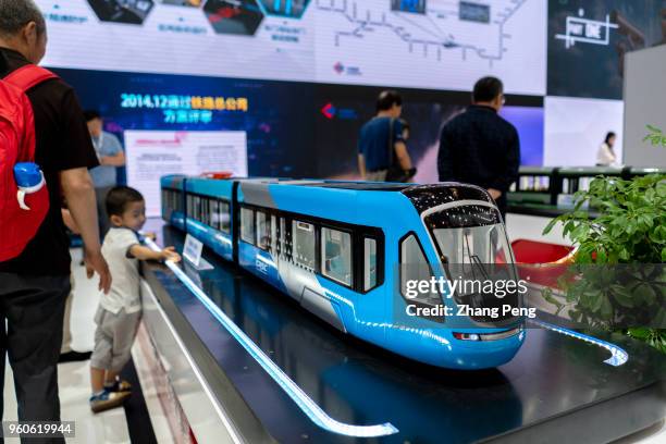 On the 2nd World Intelligence Congress, which was held in Tianjin Meijiang Exhibition Center from May 16-18, kids are attracted by various rail...