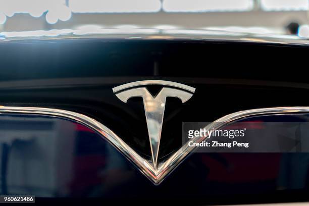 Logo on a Tesla car. People are experiencing Tesla car on the 2nd World Intelligence Congress, held in Tianjin Meijiang Exhibition Center from May...