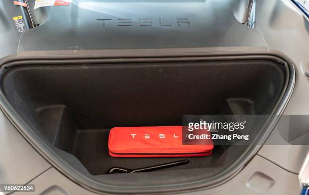 Interior of a Tesla engine area. People are experiencing Tesla car on the 2nd World Intelligence Congress, held in Tianjin Meijiang Exhibition Center...