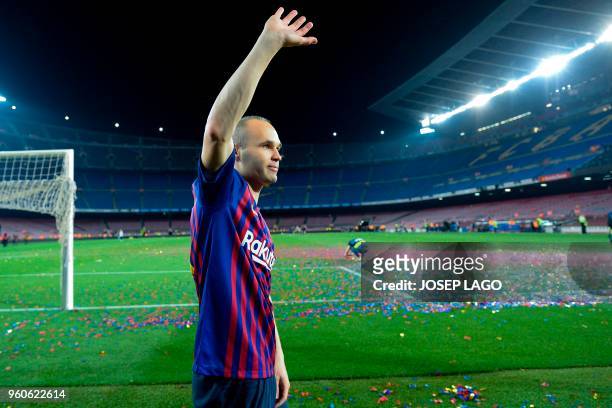 Barcelona's Spanish midfielder Andres Iniesta waves at the end of a tribute after the Spanish league football match between FC Barcelona and Real...