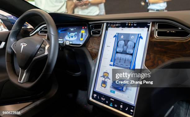 Interior of a Tesla driver's cabin. People are experiencing Tesla car on the 2nd World Intelligence Congress, held in Tianjin Meijiang Exhibition...