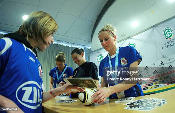 Anja Mittag of 1. FFC Turbine Potsdam signs an autograph during the T-Home DFB Indoor Cup at the Boerdelandhalle on January 23, 2010 in Magdeburg,...