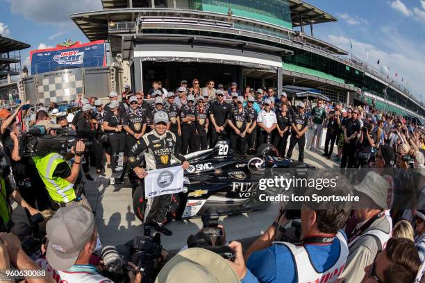 Ed Carpenter, driver of the Ed Carpenter Racing Chevrolet, holds a P1 banner and poses for photos after recording the fastest time to qualify for...