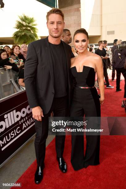 Justin Hartley and Chrishell Stause attend the 2018 Billboard Music Awards at MGM Grand Garden Arena on May 20, 2018 in Las Vegas, Nevada.