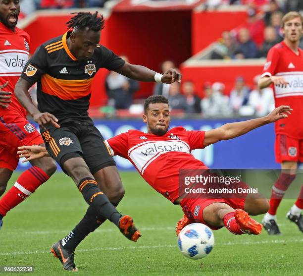 Alberth Elis of the Houston Dynamo fires a shot for a goal past the diving Johan Kappelhof of the Chicago Fire at Toyota Park on May 20, 2018 in...