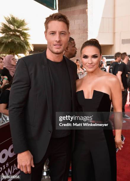 Justin Hartley and Chrishell Stause attend the 2018 Billboard Music Awards at MGM Grand Garden Arena on May 20, 2018 in Las Vegas, Nevada.