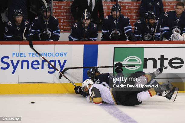 Pierre-Edouard Bellemare of the Vegas Golden Knights and Patrik Laine of the Winnipeg Jets fall on the ice during the third period in Game Five of...