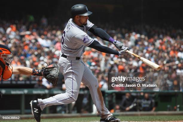 Noel Cuevas of the Colorado Rockies hits an RBI single against the San Francisco Giants during the fourth inning at AT&T Park on May 20, 2018 in San...