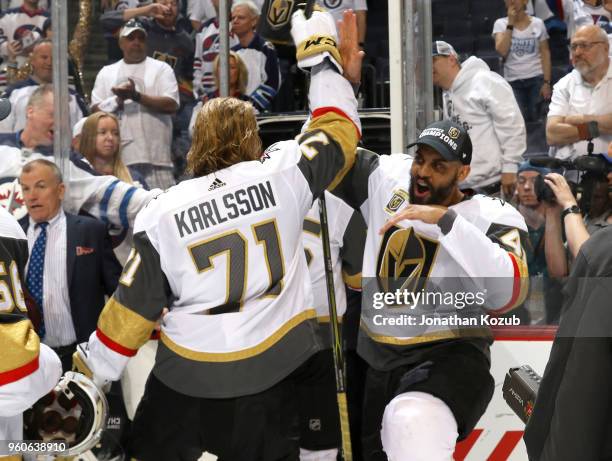 William Karlsson and Pierre-Edouard Bellemare of the Vegas Golden Knights high five as they leave the ice following a 2-1 victory over the Winnipeg...