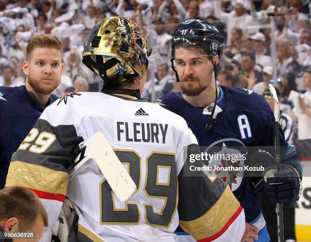 Goaltender Marc-Andre Fleury of the Vegas Golden Knights and Mark Scheifele of the Winnipeg Jets shake hands following a 2-1 Knights victory in Game...