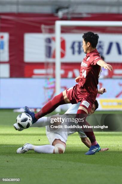 Naoyuki Fujita of Vissel Kobe and Kazuki Fukai of Consadole Sapporo compete for the ball during the J.League J1 match between Vissel Kobe and...