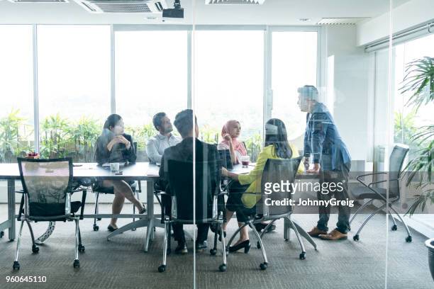 view through glass towards business meeting - showsview stock pictures, royalty-free photos & images