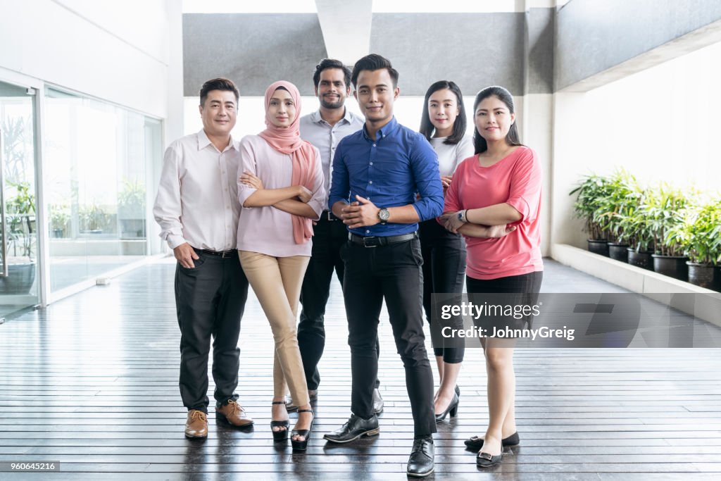 Mixed age range business colleagues in modern office