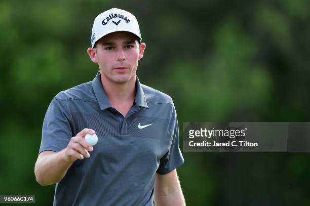 Aaron Wise acknowledges the gallery following his birdie putt on the ninth green during the final round of the AT&T Byron Nelson at Trinity Forest...