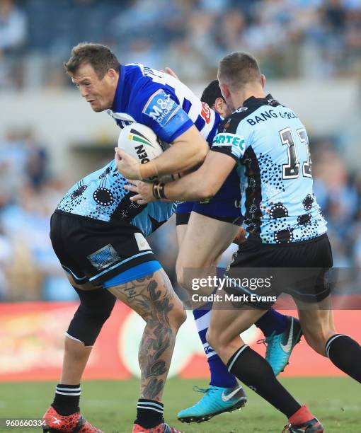 Josh Morris of the Bulldogs is tackled during the round 11 NRL match between the Cronulla Sharks and the Canterbury Bulldogs at Southern Cross Group...