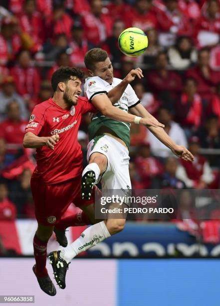 Santos' Argentinian forward Julio Furch vies for the ball with Toluca's Argentinian defender Santiago Garcia , during their Mexican Clausura 2018...