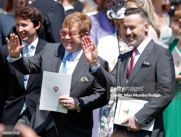 Elton John and David Furnish attend the wedding of Prince Harry to Ms Meghan Markle at St George's Chapel, Windsor Castle on May 19, 2018 in Windsor,...
