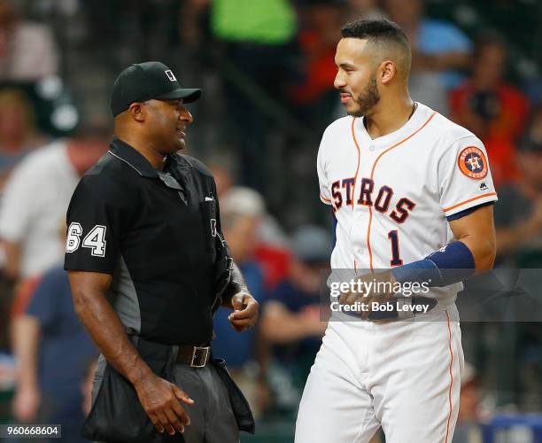 Carlos Correa of the Houston Astros talks with home plate umpire Alan Porter after he called out on strikes looking in the third inning against the...