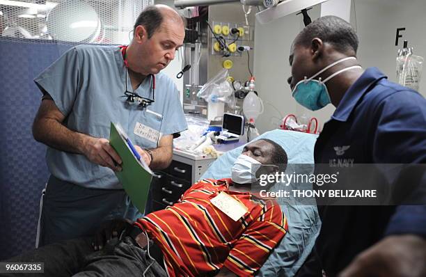 An earthquake victim is attended to aboard the USNS Comfort hospital ship in the harbour off Port-au-Prince on January 23, 2010. More than 110,000...