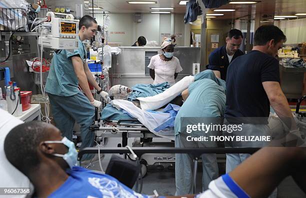 An earthquake victim is attended to aboard the USNS Comfort hospital ship in the harbour off Port-au-Prince on January 23, 2010. More than 110,000...