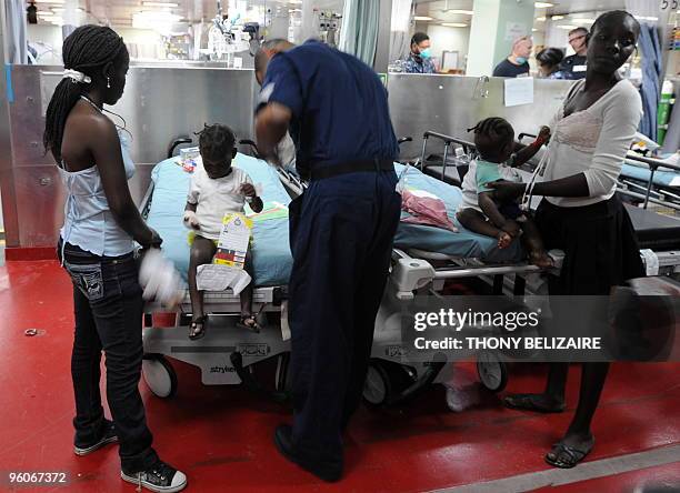Two Haitian children are attended to aboard the USNS Comfort hospital ship in the harbour off Port-au-Prince on January 23, 2010. More than 110,000...