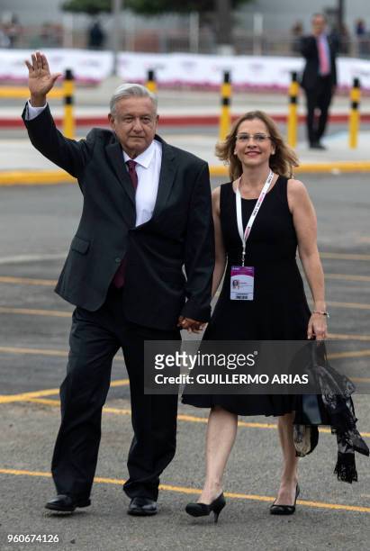 Mexico's presidential candidate for the MORENA party, Andres Manuel Lopez Obrador waves next to his wife Beatriz Gutierrez upon arrival at the...