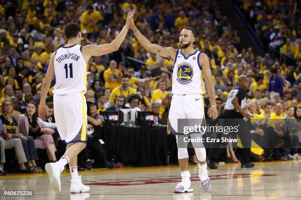 Stephen Curry and Klay Thompson of the Golden State Warriors react after a plat against the Houston Rockets during Game Three of the Western...