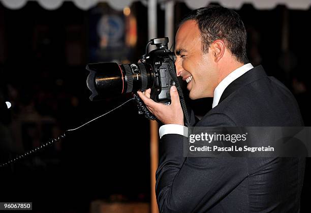 Presenter Nikos Aliagas takes a picture as he arrives at Palais des Festivals to attend NRJ Music Awards on January 23, 2010 in Cannes, France.